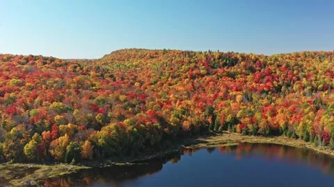 Aerial view, slowly backing up over the lake revealing the mountain Stock Footage 163983145