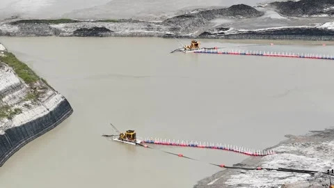 An aerial view of a sludge suction machine extracting mud at a vast and dee.. Stock Footage 344614635