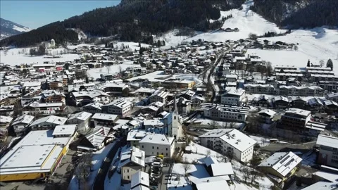 Aerial view of a small alpine town in winter Stock Footage 276133650