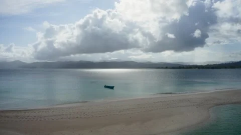Aerial view of a small boat floating in calm turquoise water, Indonesia. Stock Footage 333328387