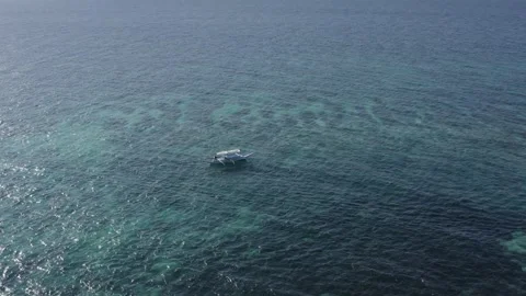 Aerial View of Small Boat Floating on Clear Water Off Puka Shell Beach, Boracay Stock Footage 340258719