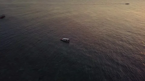 Aerial View of Small Boat Floating on Ocean Waters at Sunset 스톡 동영상 344864485
