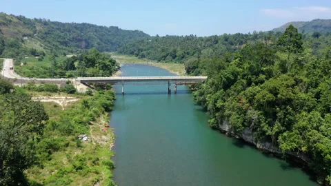 Aerial view of a small bridge crossing a river in a rural area 4k Stock Footage 265078175