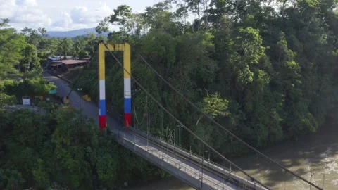 Aerial view of a small bridge painted in the colors of the ecuadorian flag Stock Footage 146343872
