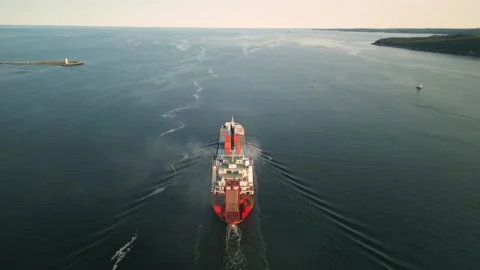 Aerial view of a small cargo container ship leaving the harbor, Canada. Stock Footage 255441741