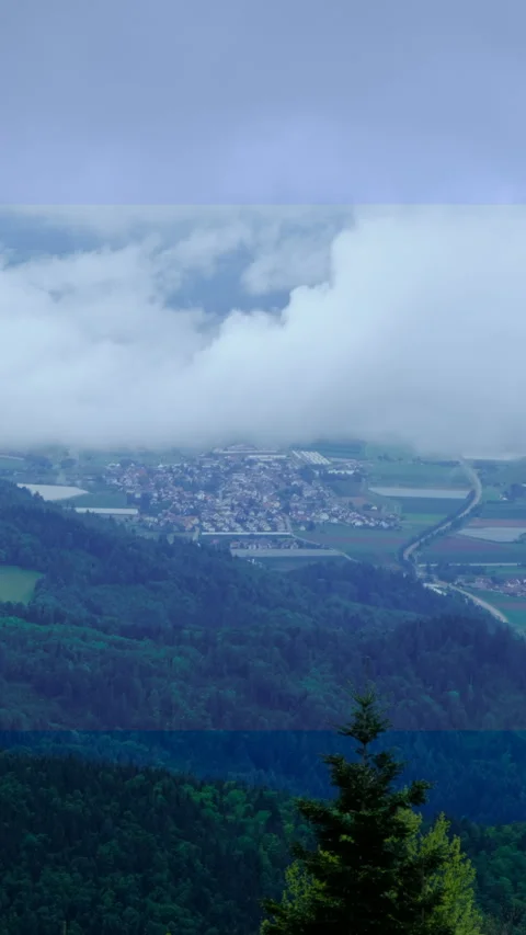 Aerial view on a small cloud above the town in valley Stock Footage 278100580