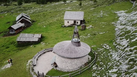 Aerial view of small curch on a Dolomites Alpine path Stock Footage 114129935