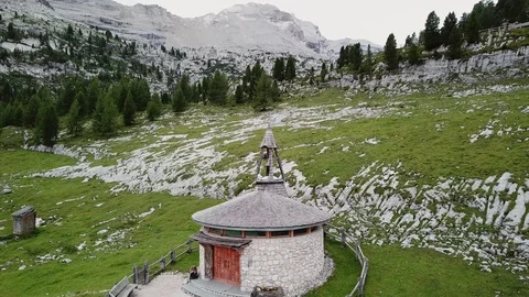 Aerial view of small curch on a Dolomites Alpine green grass Stock Footage 114355490