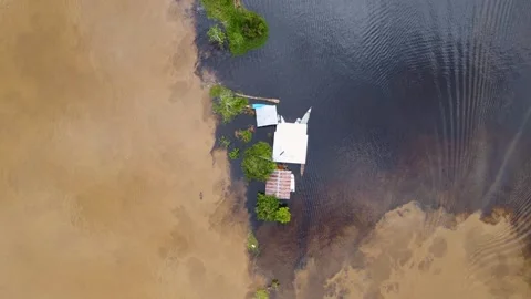Aerial view of a small house on the Amazon River Stock Footage 330925789