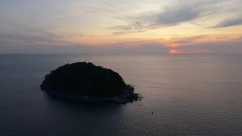 Aerial view of small island at sunset over calm ocean waters Video stock 342312647