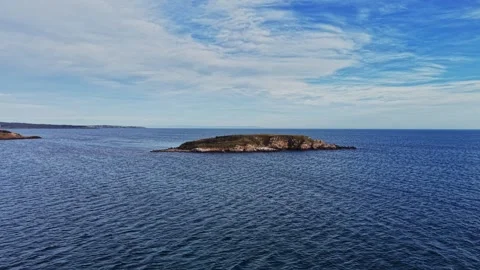 Aerial view of a small island surrounded by calm ocean waters Stock Footage 325720162