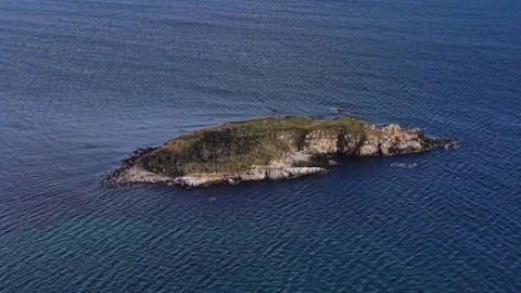 Aerial view of a small island surrounded by calm blue waters Stock Footage 325720393