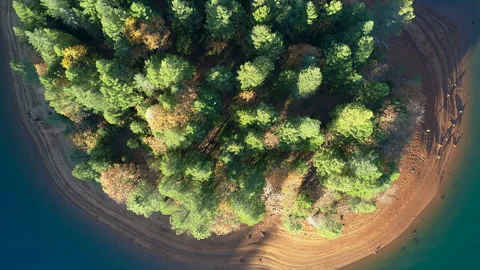 Aerial view of a small island surrounded by clear blue water Stock Footage 344773632