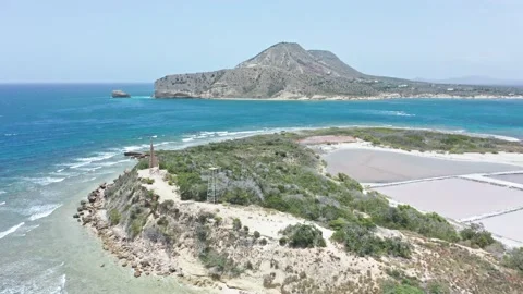 Aerial view of small islet - Isla Cabra lighthouse structure and salt pans 動画素材 196924374