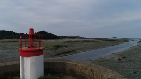 Aerial view. Small lighthouse for navigation on sluice in fairway at low tide. Stock-Footage 120028733