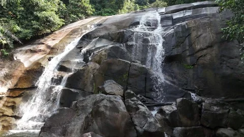 Aerial view of a small mountain  through rocks and lush green forest. Stock Footage 340594565