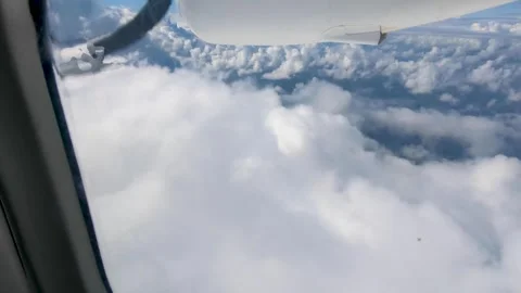 Aerial view small propeller airplane window flying through white fluffy clouds Stock Footage 339765469