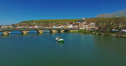Aerial view of small river boat sails on the river Yonne in France passing a 動画素材 316818686