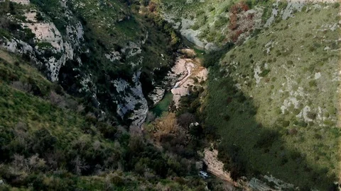 Aerial view of a small river at the bottom of a canyon in Cavagrande (Sicily) Stock Footage 103309435