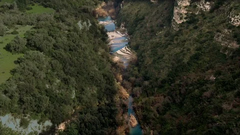 Aerial view of a small river at the bottom of a canyon in Cavagrande (Sicily) Stock Footage 104125116