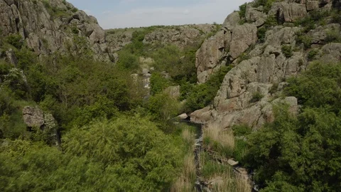 Aerial view of a small river flowing in a canyon in nature reserve drone footage Stock Footage 114601717