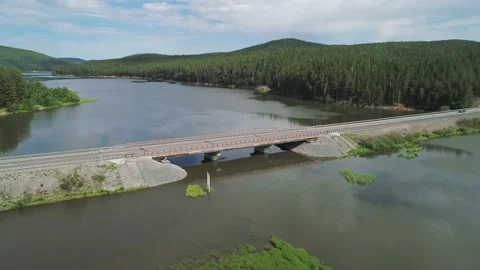 Aerial view of small road bridge across the river in rural area. Car is driving Stock Footage 196297341