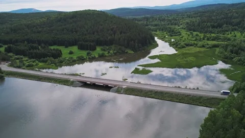 Aerial view of small road bridge across the river in rural area. Cars driving on Stock-Footage 196298346