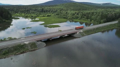 Aerial view of small road bridge across the river in rural area. Lorry is Stock Footage 196298613