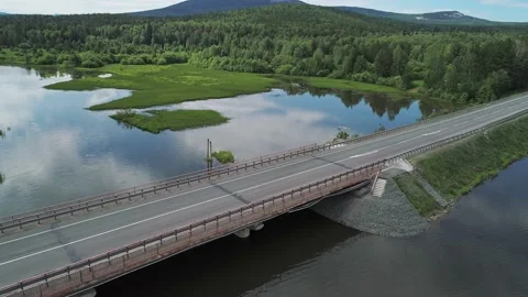 Aerial view of small road bridge across the river in rural area. Sky reflections Video stock 196298761