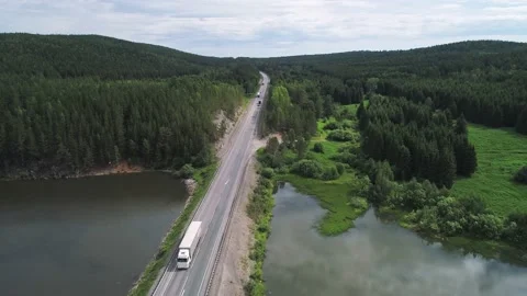 Aerial view of small road bridge across the river in rural area. Cars driving on Vídeo Stock 196299293