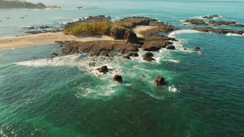 Aerial view of small rocks and sandy beach San Juanillo in Costa Rica Stock Footage 317723311