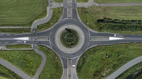 Aerial view of a small roundabout at the intersection of two asphalted Stock Photos