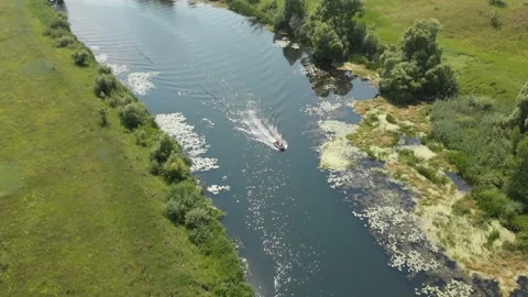 Aerial view. A small rubber fishing boat with a motor is moving quickly on a Stock Footage 111229341