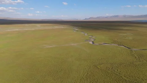 Aerial view of a small stream on the vast alpine steppe, Kyrgyzstan Stock Footage 347240898