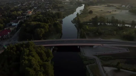 Aerial View of Small Three Lane Bridge Over the Long Calm River Stock Footage 138518213