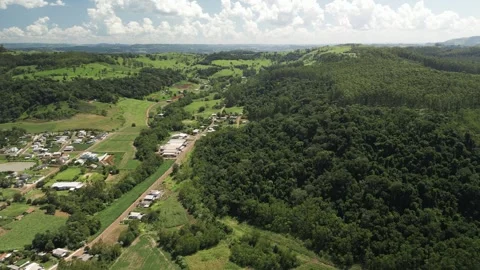 Aerial view of a small town among green fields in a beautiful day. Stock Footage 253366918