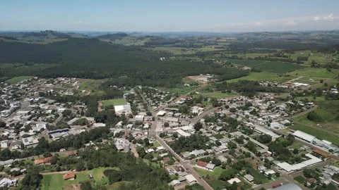 Aerial view of a small town among green fields in a beautiful day. Stock Footage 253401828