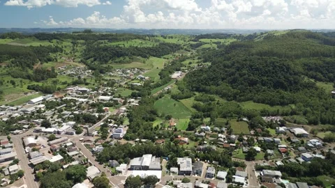 Aerial view of a small town among green fields in a beautiful day. Stock Footage 253401864