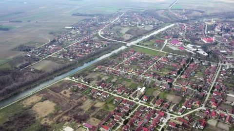 Aerial view of small town Bac in Serbia and canal DTD flowing through Stock-Footage 258608903