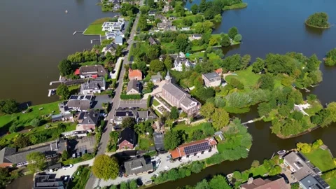 Aerial view of a small town with a central church and tall steeple 動画素材 317447538
