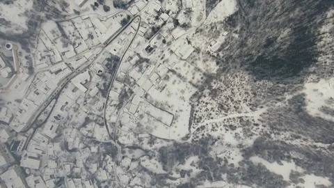 Aerial view of small town with hills in winter. Stock Footage