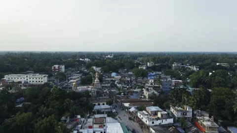 Aerial view of a small town with homes, streets and a church dome surrounde.. 動画素材 338302289