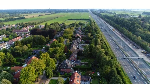 Aerial view of small town located alongside busy two lane highway 4k Stock Footage 124833700