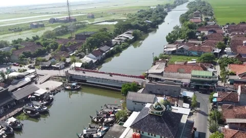 Aerial view of a small town with river and green fields Stock-Footage 279136748
