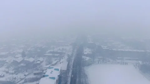 Aerial view of small town in snowfall. Blizzard. Snowstorm. Stock Footage 120784465