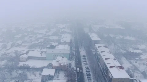 Aerial view of small town in snowfall. Blizzard. Snowstorm. Stock Footage 120785229