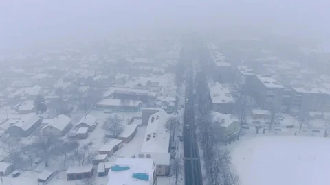Aerial view of small town in snowfall. Blizzard. Snowstorm. Stock Footage 120785664