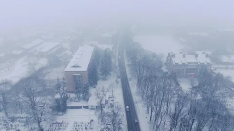 Aerial view of small town in snowfall. Blizzard. Snowstorm. Stock Footage 120786117