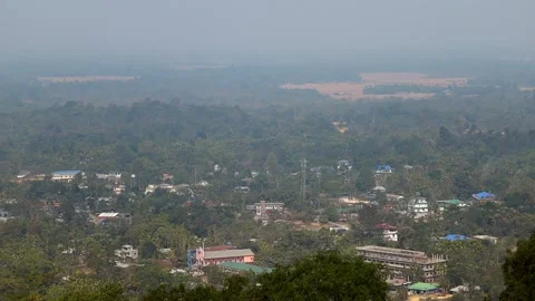 Aerial View of Small Town Surrounded by Dense Green Forest Stock Footage 328825449
