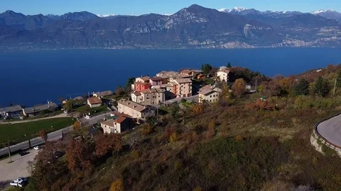 Aerial view of a small village on the shores of Lake Garda in autumn. Stock Footage